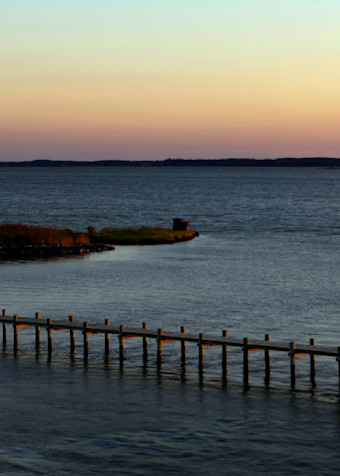 The sun sets over Hooper Island during calm Fall day on Chesapeake Bay, Maryland.