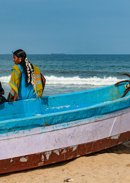 Couple on fishing boat, Marina Beach, Chennai, India