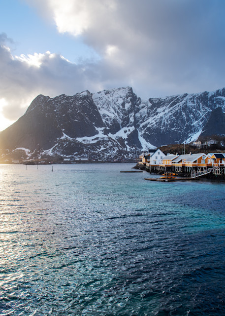 Fishing village in lofoten norway at sunset with fjords in the distance