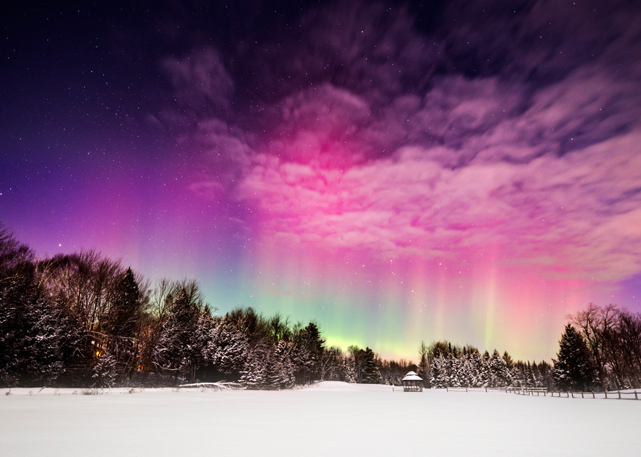 Moonlight Aurora, moon shines on a winter field while aurora borealis peeks through the clouds