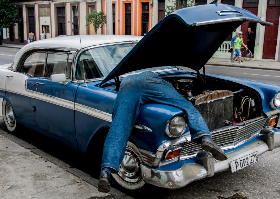 Man in engine of old classic blue car, art photograph print