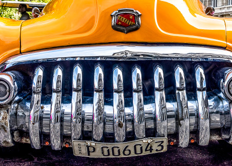 Panorama of old yellow Buick from the front with shiny chrome grille, art photograph