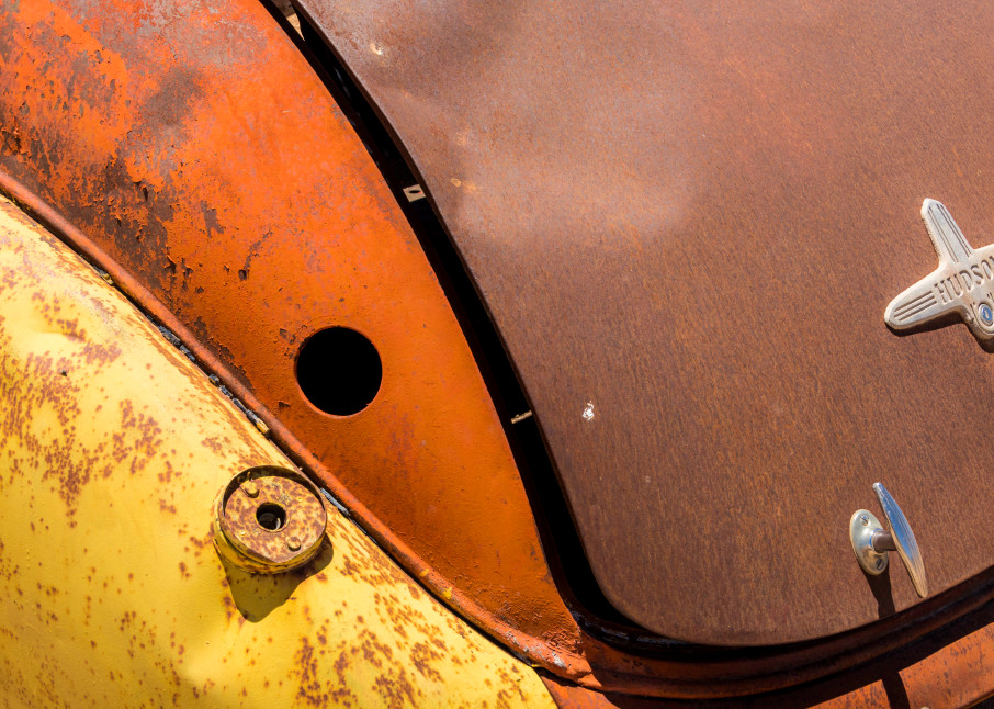 close-up of the back of an old rusting colorful Hudson car in an art photograph