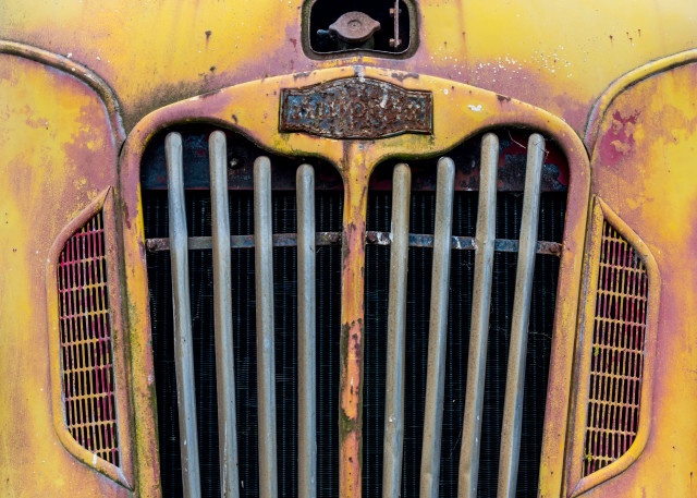 Front view of old classic fire truck in yellow and pink, art photograph