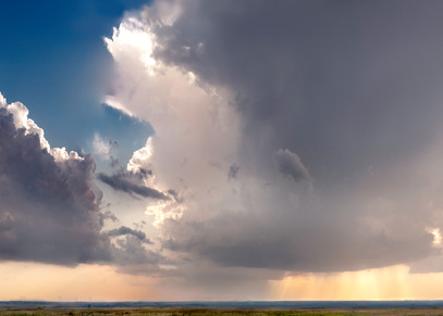 Golden Light Collection - color | Storm in the West, the Kansas Flint Hills. Thunderheads lit by the golden light of evening. Fine art color photograph by David Zlotky.