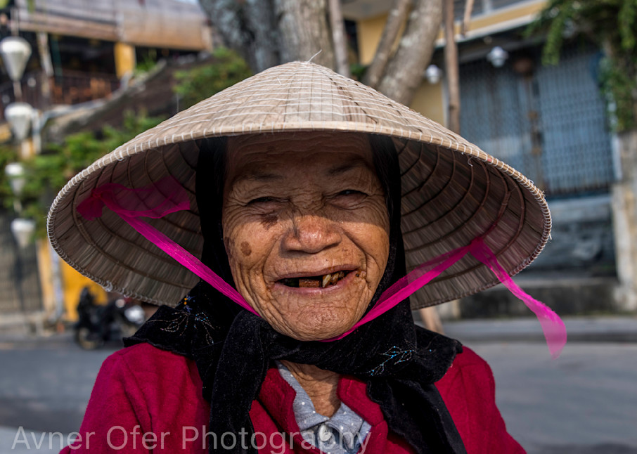 Old woman with conical hat and big smile