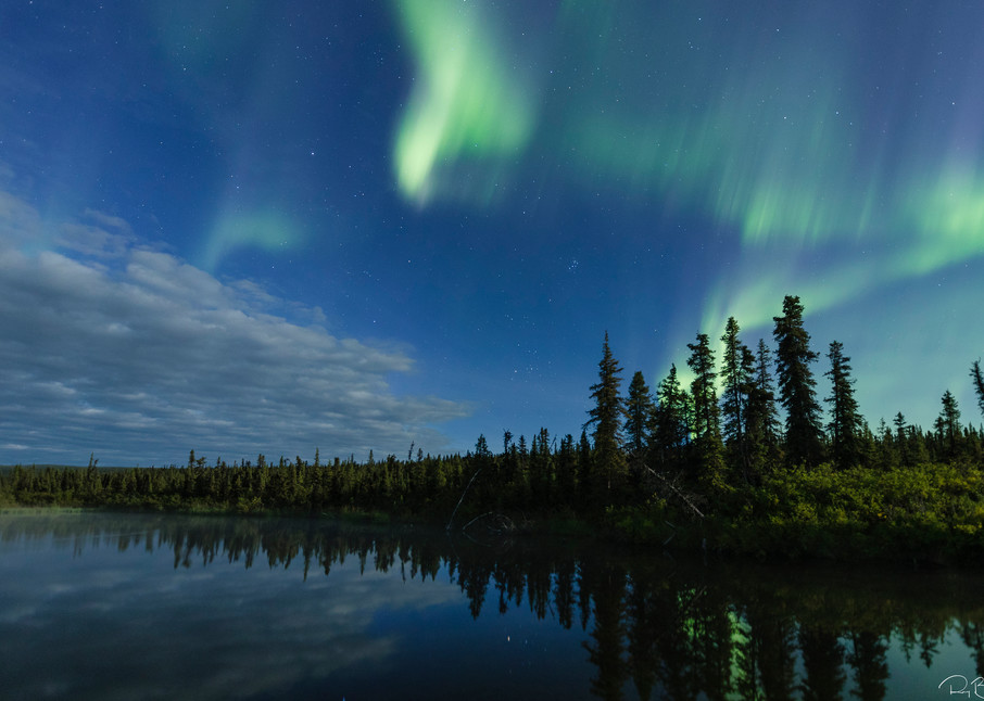 Aurora Borealis over Paxson Lake in Interior Alaska. Summer. Evening.