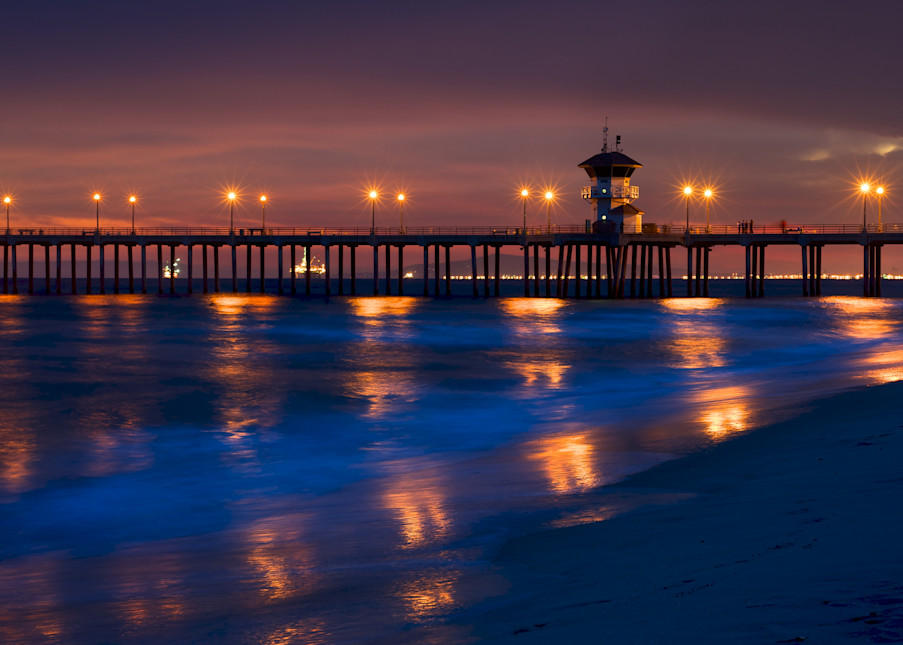photo of the huntington beach pier with reflected lights on the water