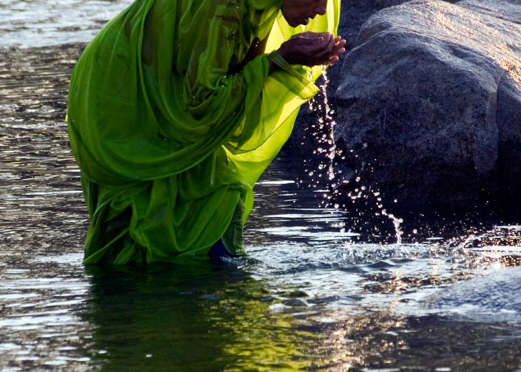 Woman bathing in river in Orchha India