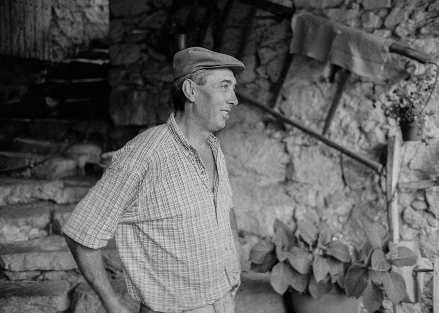 Les Vignolles, France - 30 July 1998. A farmer outside his home near Les Vignolles in the Cécvennes in the south of France. His wife is a cheesemaker, and makes pelardon, a local goat cheese.