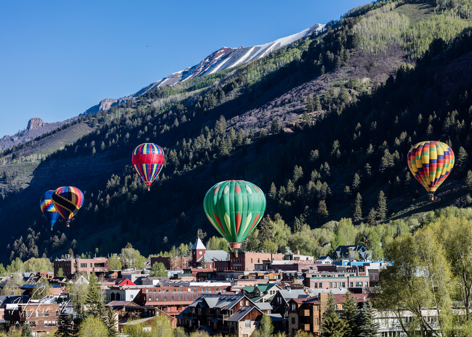 Colorful and cleverly designed hot-air balloons ascend shortly after dawn, when the sky is most often fair and winds calm, at the annual Telluride Balloon Festival in that old Colorado mining town turned popular skiing destination -- but not in Spri