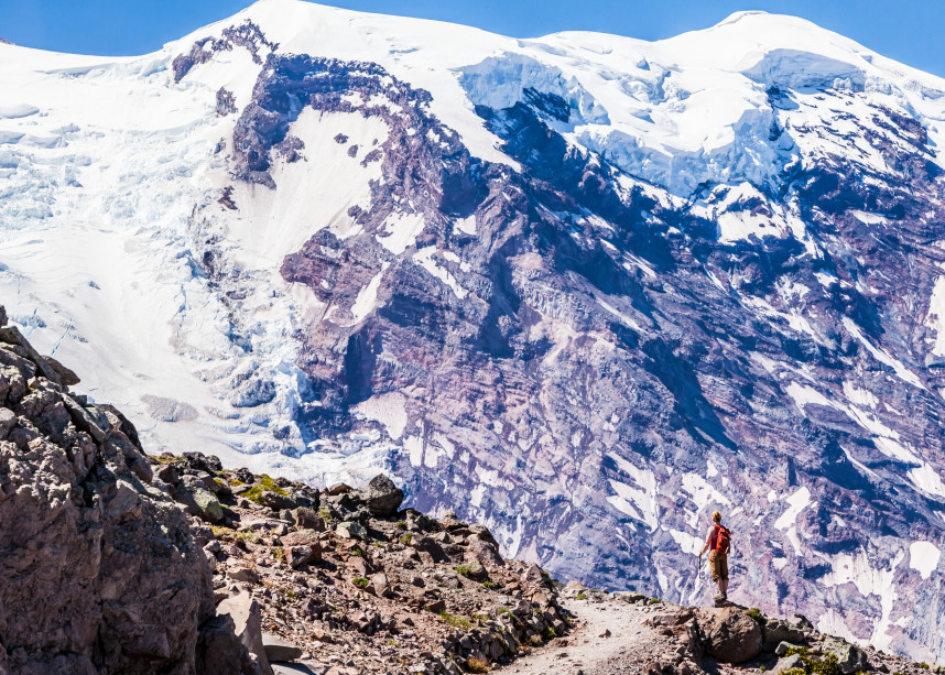 A woman hiking on First Burroughs Mountain below Mount Rainier, Washington, USA