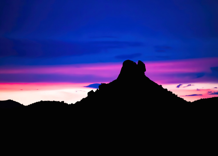 Desert Sunset Sky with Bands of Color and Mountain in Silhouette