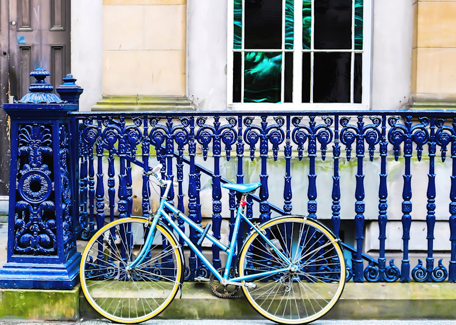 Blue Bike Leans Against Blue Iron Railing in Scotland