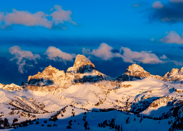 May 8, 2022 - Alta, WY: Looking east at the Teton Mountain Range from the summit of Fred's Mountain and the Grand Targhee Resort, moments before sunset.