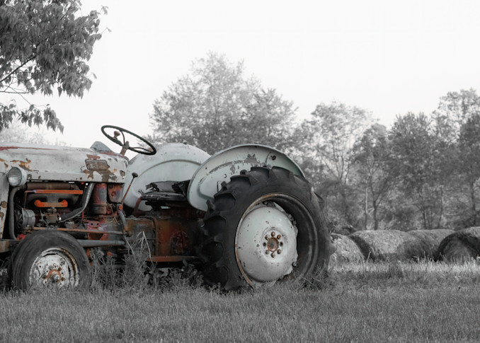 An Old Ford Tractor In A Hay Field Print