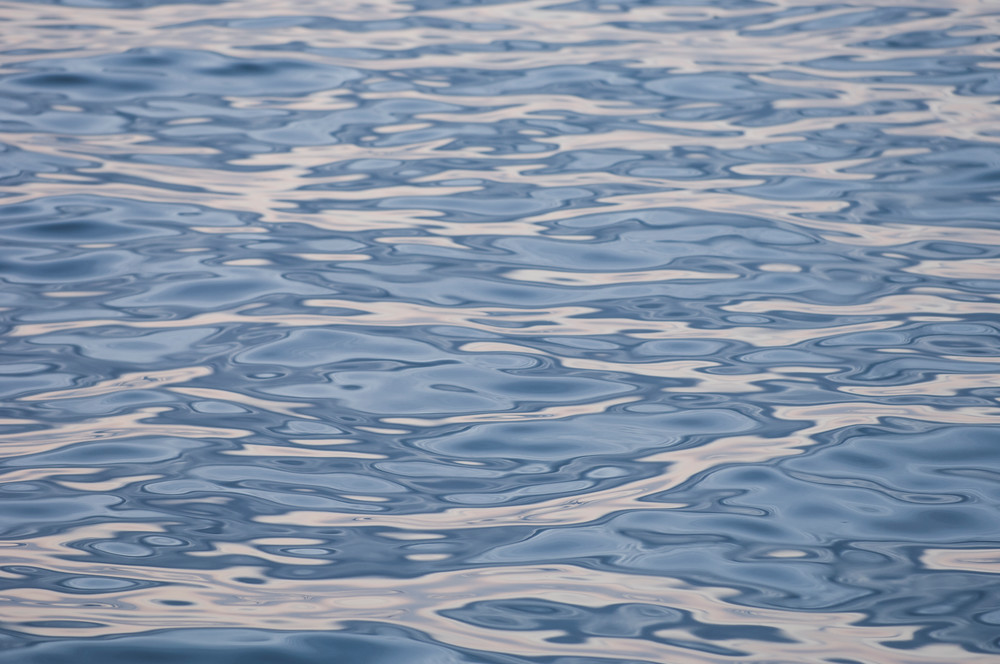 Santa Cruz Island, Channel Islands, California; ripple patterns on the surface of the water reflect the colors in the later afternoon sky