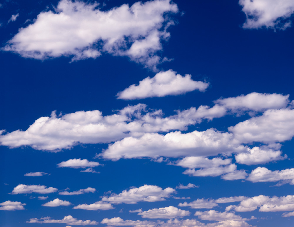 Fine art image of Cumulus clouds against a blue sky by Greg Probst