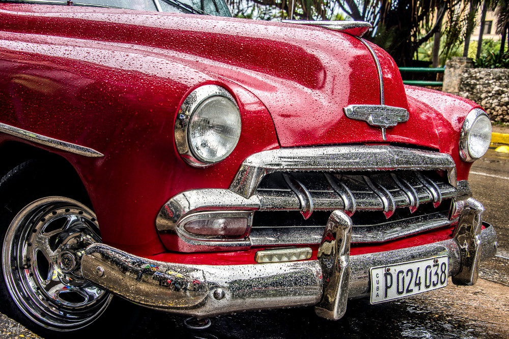 Red 1952 chevy with chrome grille and rain drops
