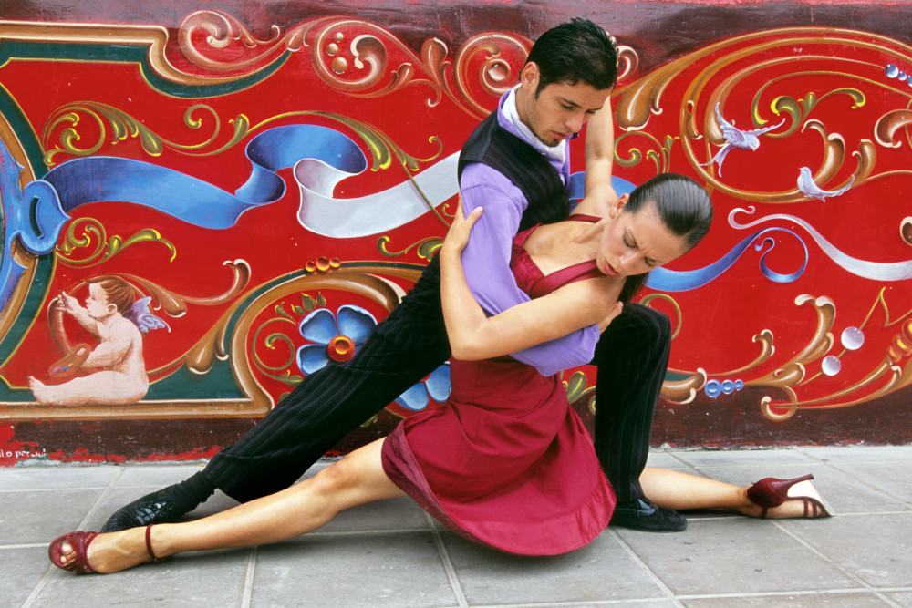 Tango art dancer in extreme pose in front of colorful mural, photograph print.