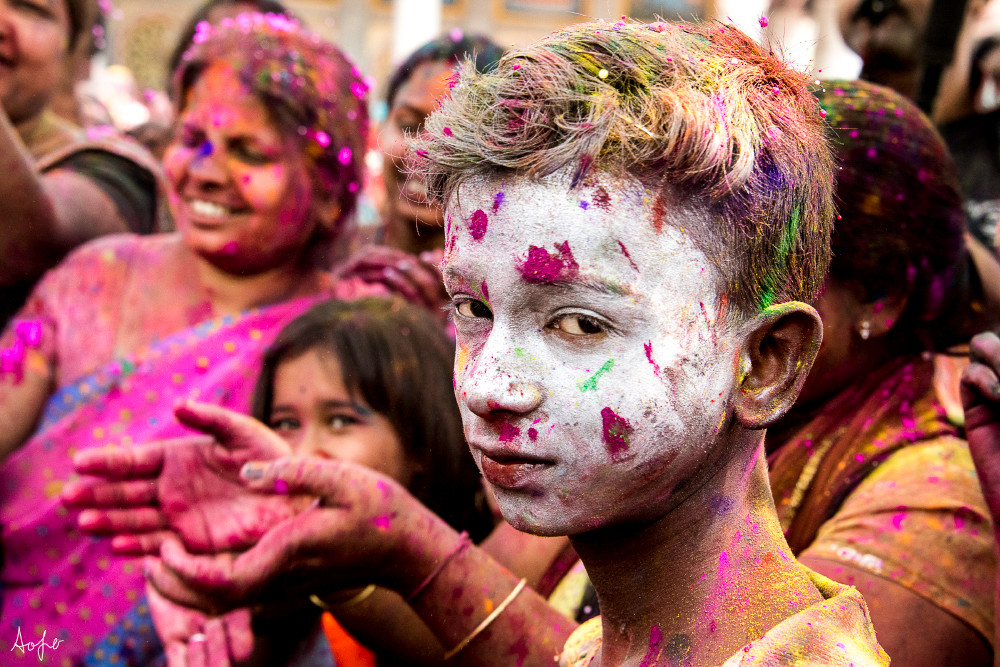 Portrait of boy with white powder on face, during Holi festival in a fine art photograph 