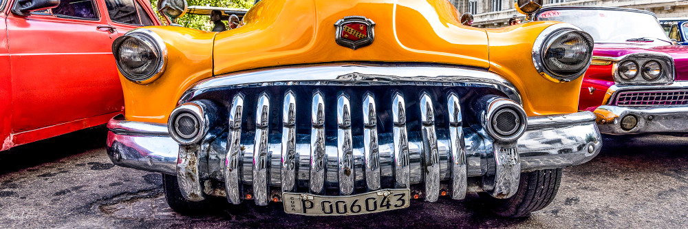 Panorama of old yellow Buick from the front with shiny chrome grille, art photograph