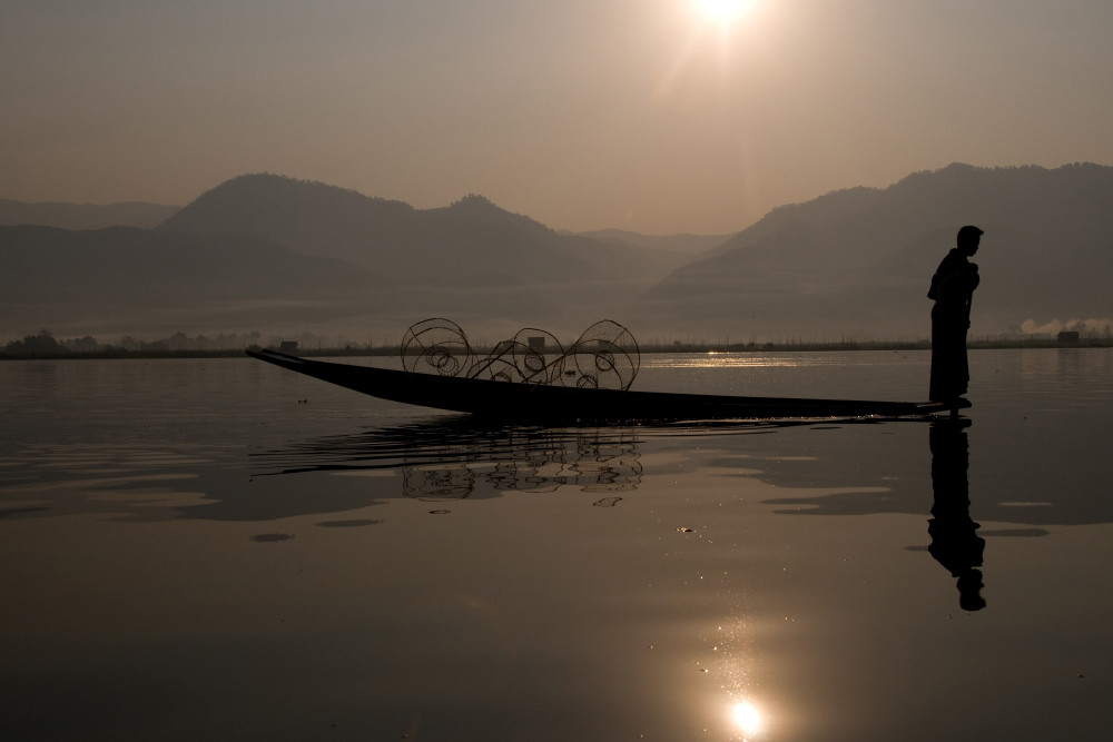 fine art photograph of foot rower in silhouette with perfect reflection