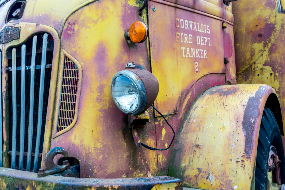 An old fire truck in yellow and pink with nice front grille in art photograph