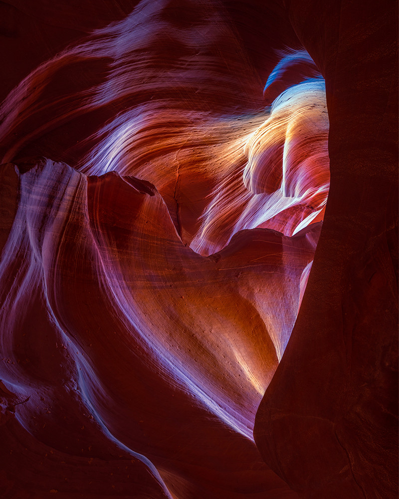 Romantic color photo of light streaming through heart rock