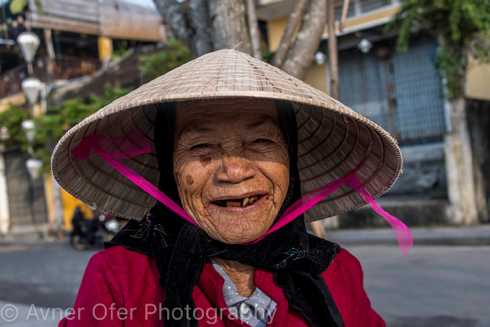 Old woman with conical hat and big smile