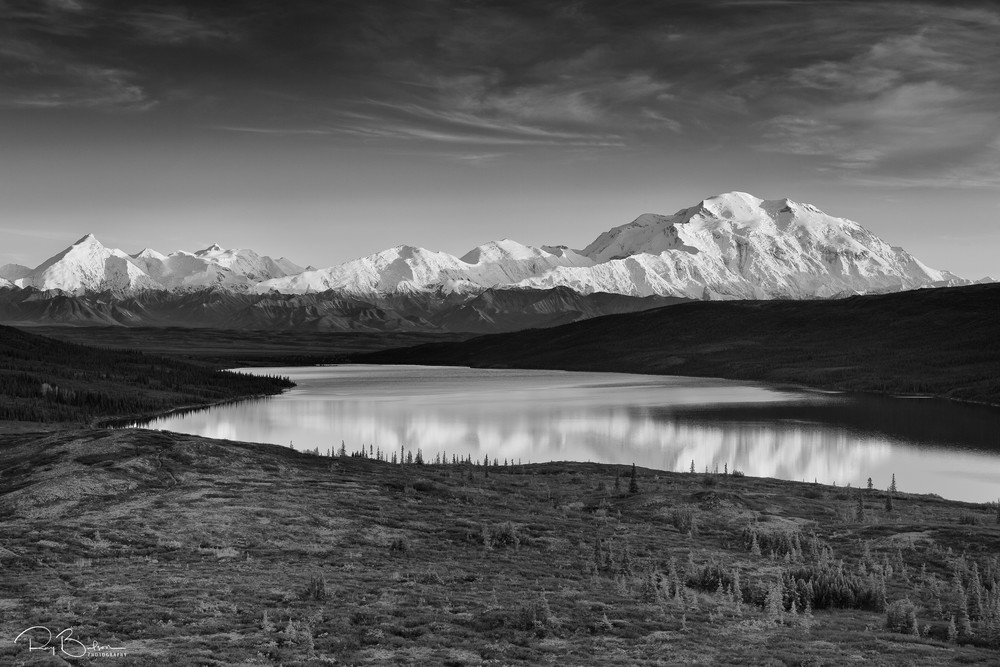 Alpenglow on Denali (Mt. McKinley) and the Alaska Range with Wonder Lake in foreground in Denali National Park in late fall in Southcentral Alaska. Evening.