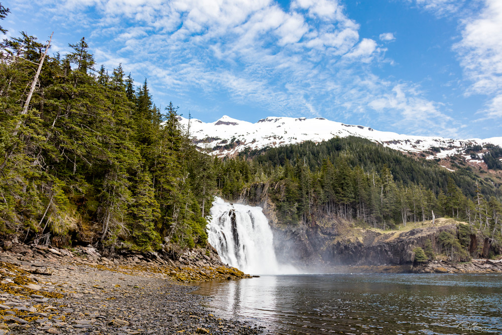 Large waterfall empties into Cascade Bay in Prince William Sound in Southcentral Alaska. Spring. Afternoon.