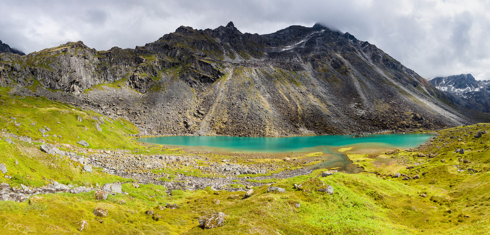 Composite panorama of Lower Reed Lake and Talkeetna Mountains from Reed Lakes Trail in Archangel Valley at Hatcher Pass in Southcentral Alaska. Summer. Afternoon.