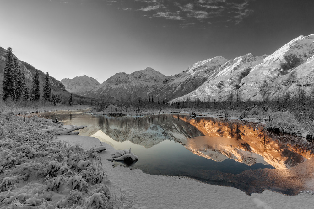 Dawn light illuminates the season's first snow as it blankets Eagle River Valley and the Chugach Mountains in Southcentral Alaska. Winter.