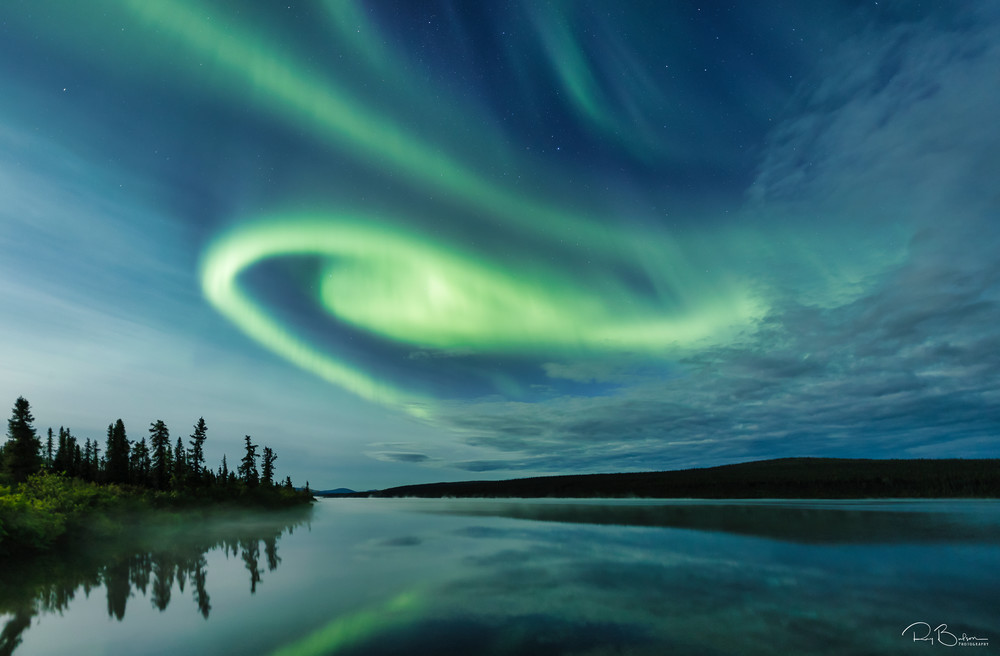 Aurora Borealis over Paxson Lake in Interior Alaska. Summer. Evening.