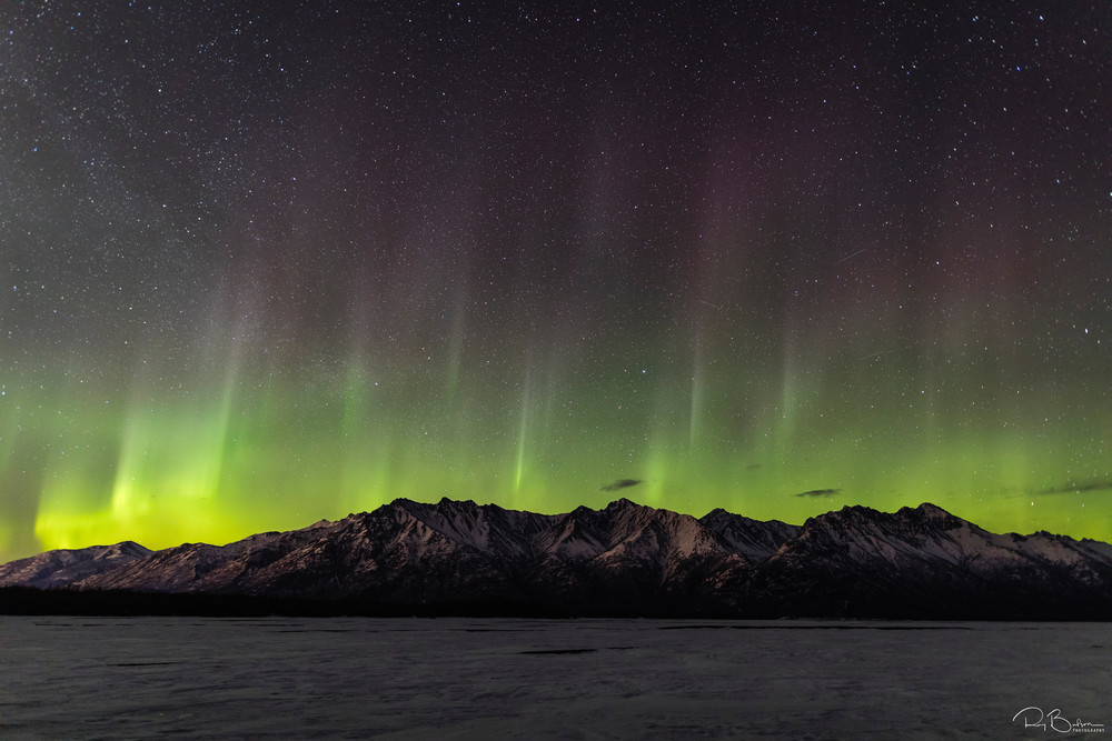 Aurora Borealis over the Chugach Mountains and the Knik River in Southcentral Alaska. Spring. Evening.