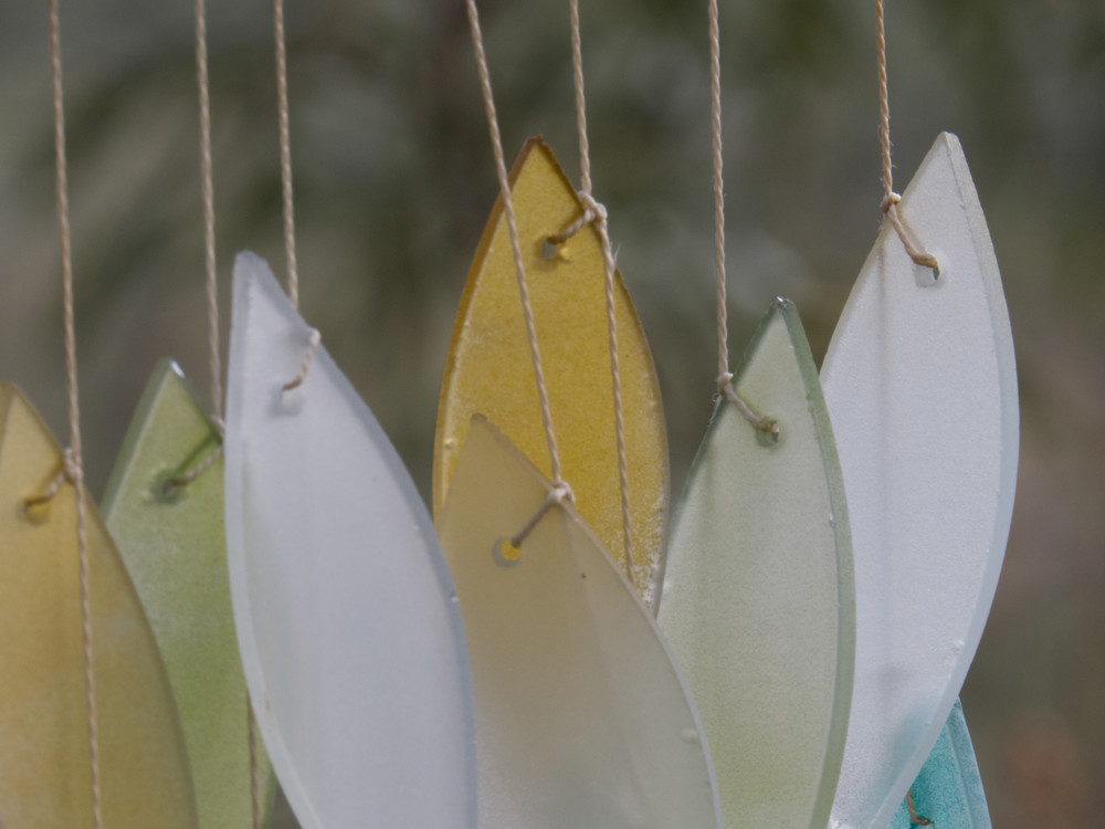 Photo of abstract oval pieces of colored glass with beach colors. 