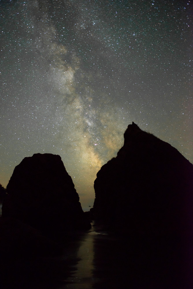 A beautiful fine art print of the Milky Way rising over sea stacks at Ruby Beach by Greg Probst