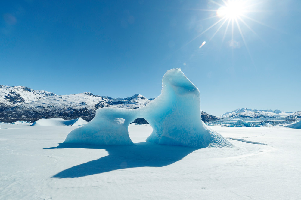 Spring landscape of ice bergs frozen into Inner Lake George, Colony Glacier.    Chugach Mountains.  Alaska   Sunny day-- blue sky

Photo by Jeff Schultz/  (C) 2020  ALL RIGHTS RESERVED