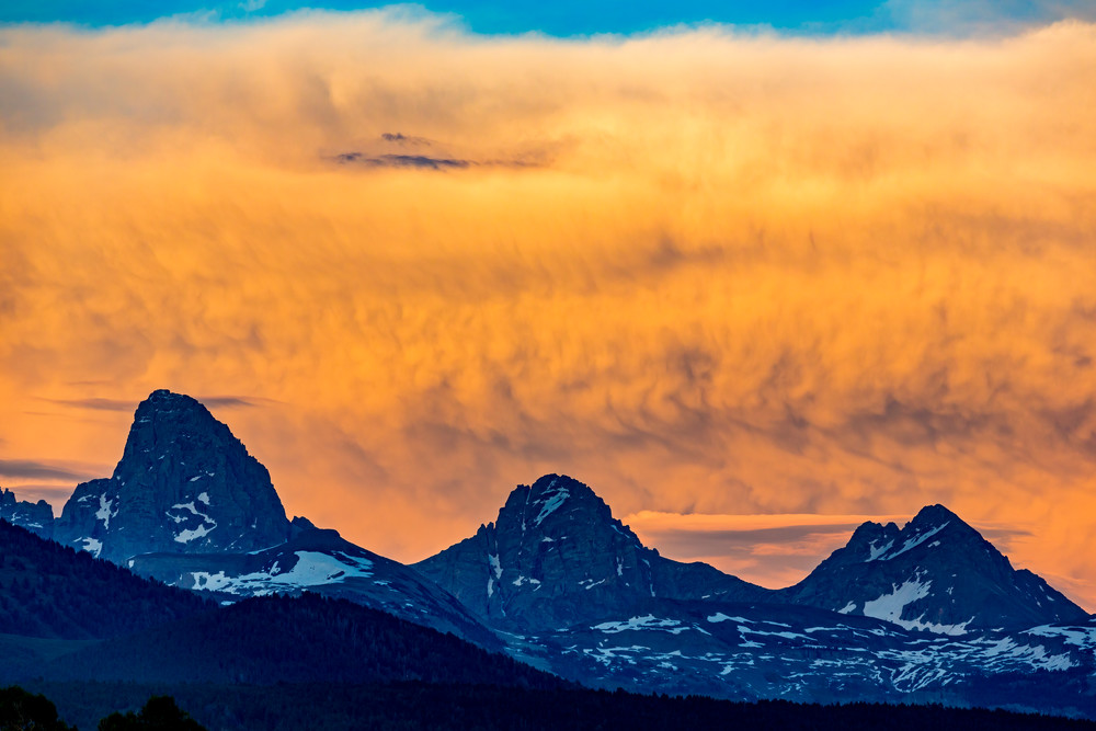 July 15, 2019 - Tetonia, ID: The Tetons bathed in sunset light seen from Broward's yard.