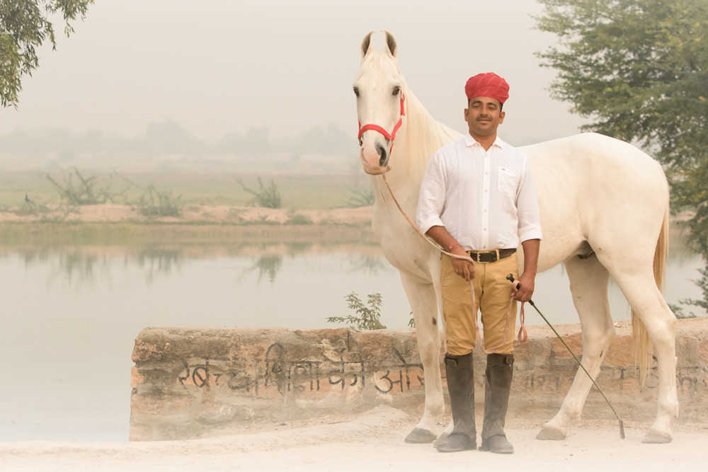 Horse Trainer poses with White Marwari Horse