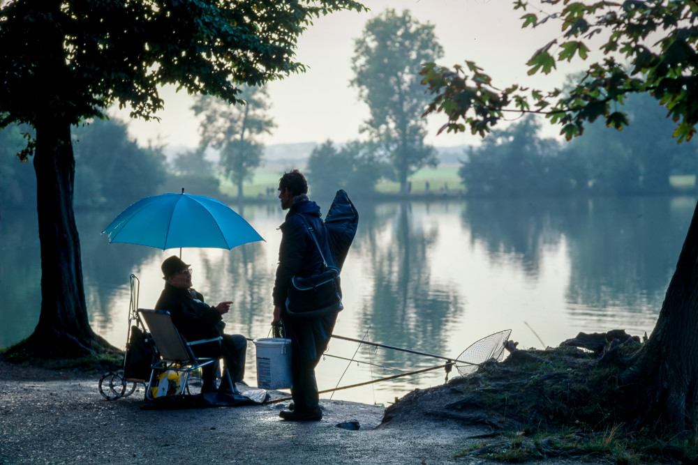 Two fishermen at a lake on the grounds of a hotel near Stuttgart, Germany.