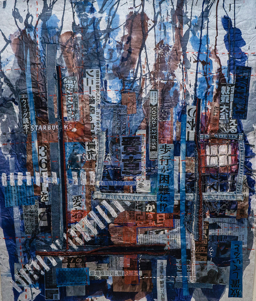 Shibuya Crossing” by Muffy Clark Gill is from a series of mixed media artwork. A 2019 indigo and Shibori workshop trip to Japan provided the subject matter. Chaos, clutter, and color were feelings evoked while viewing the scenes in transit at Shibuy
