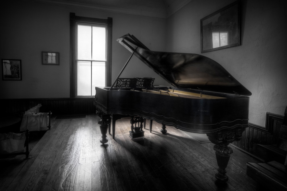 A well used piano sits quietly in an old country church in the ozarks.