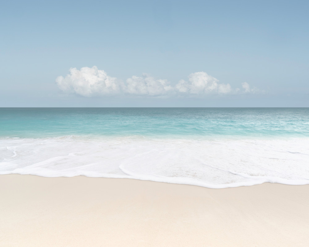 A fine art seascape photograph of water foam on the sand in Anguilla by Mia DelCasino.