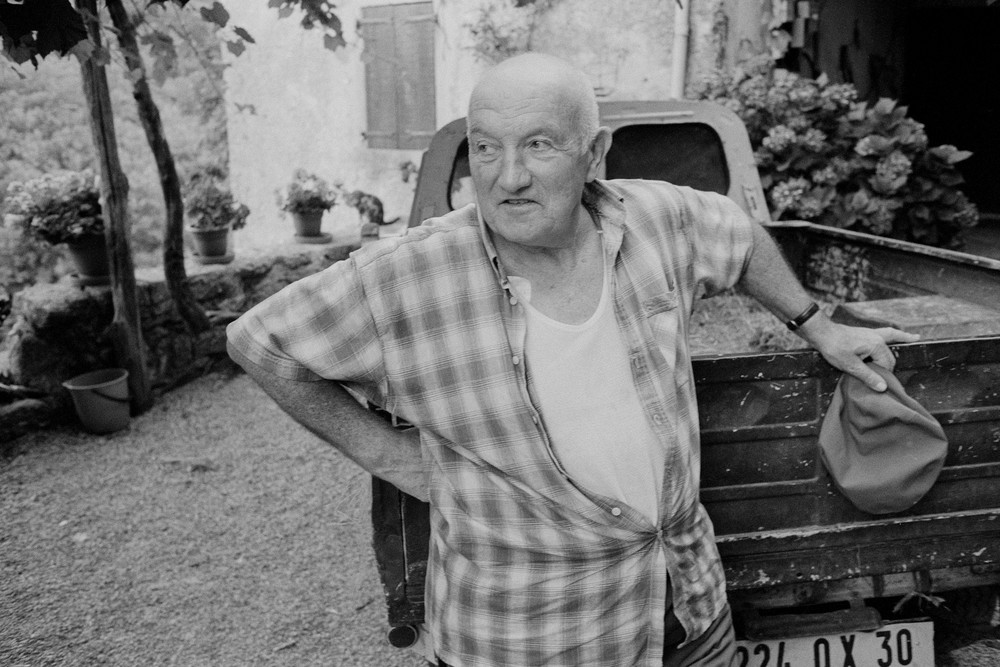 Les Vignolles, France - 30 July 1998. A farmer leans on his  truck at the end of the day on a farm newar les Vignolles, in the Cévennes, in the Gard department in the south of France.