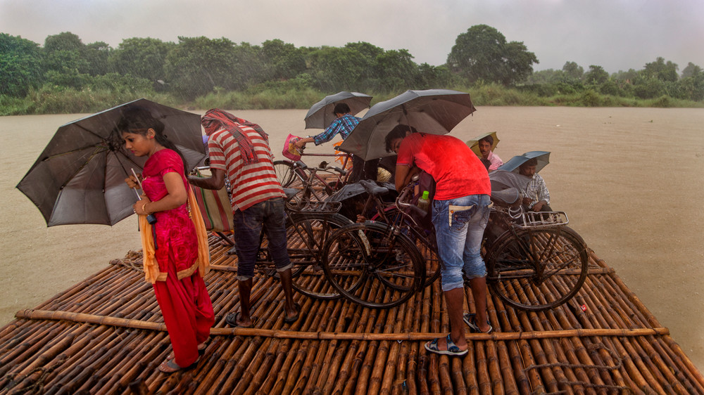 Young Woman Under An Umbrella Braced Against The Rain, Ganges River Ferry,  Matiari, India Photography Art | davidarnoldphotographyart.com