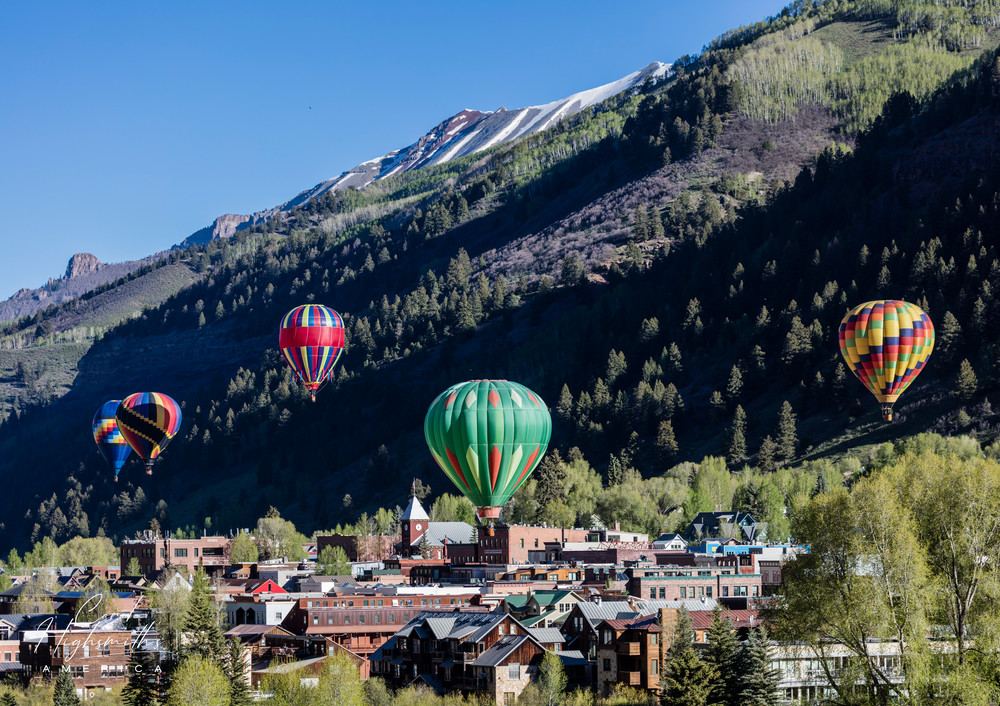 Colorful and cleverly designed hot-air balloons ascend shortly after dawn, when the sky is most often fair and winds calm, at the annual Telluride Balloon Festival in that old Colorado mining town turned popular skiing destination -- but not in Spri