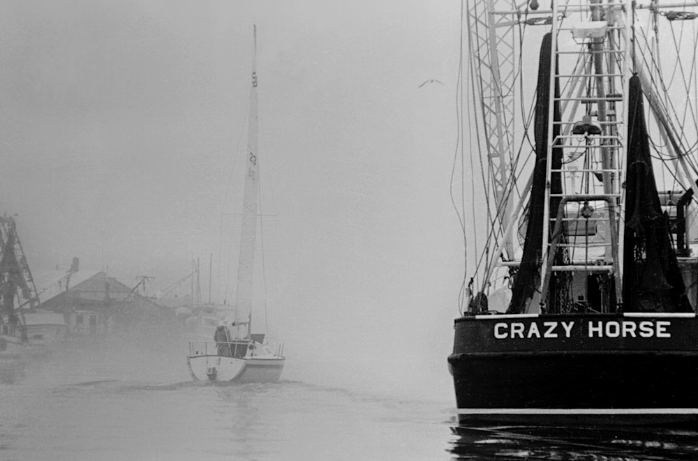 Crazy Horse fishing shrimp boat with sailboat cruising by in the fog