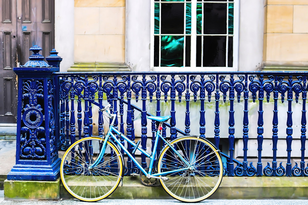 Blue Bike Leans Against Blue Iron Railing in Scotland